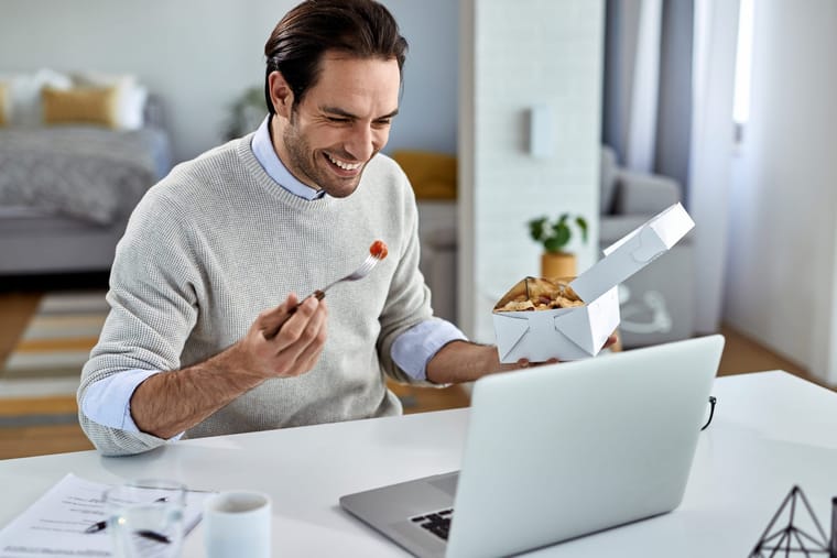 happy-businessman-surfing-net-laptop-his-lunch-break-home-2048x1365.jpg